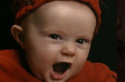Close view of baby in red with mouth open 