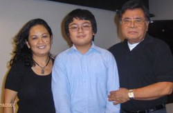 Family with boy in center flanked by his parents