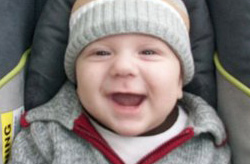 Close up of smiling baby wearing winter cap