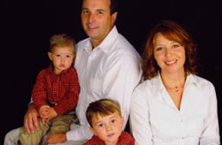 Family portrait with seated parents and two young boys