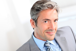 A man in a suit sitting at home