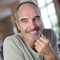 A man smiling in his home