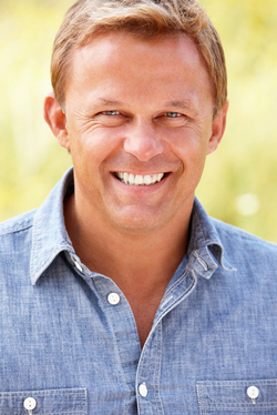 A man smiling while outdoors