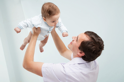 A father and his baby playing together