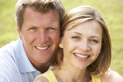 A happy couple smiling outdoors