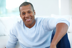 Happy man in blue shirt relaxing at home.          