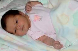 Infant girl lying in bed