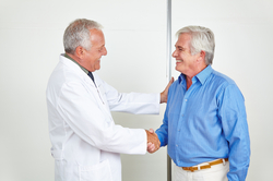 A male patient shaking hands with his urologist after a successful vasectomy reversal